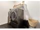 Laundry room featuring modern washer and dryer units with shelving at 22609 E Roundup Way, Queen Creek, AZ 85142