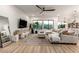 Inviting living room with lots of natural light, a stylish ceiling fan, and neutral decor at 22609 E Roundup Way, Queen Creek, AZ 85142