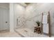 Luxurious shower featuring rainfall showerhead, mosaic tile floor, and elegant white marble walls, creating a spa-like retreat at 22609 E Roundup Way, Queen Creek, AZ 85142