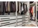 Organized walk-in closet with ample hanging space, shelving, and drawers, providing efficient and stylish storage solutions at 22609 E Roundup Way, Queen Creek, AZ 85142