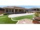 Lush backyard featuring pavers and turf, perfect for outdoor relaxation and recreation at 2310 W Sienna Bouquet Pl, Phoenix, AZ 85085