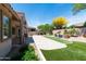 Expansive backyard with artificial turf and water feature, ideal for relaxation and outdoor activities at 2310 W Sienna Bouquet Pl, Phoenix, AZ 85085