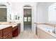 Primary bathroom with soaking tub and dual sinks at 2310 W Sienna Bouquet Pl, Phoenix, AZ 85085