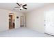 Spacious bedroom with a ceiling fan, bathroom, and balcony access at 2310 W Sienna Bouquet Pl, Phoenix, AZ 85085
