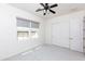 Neutral bedroom with ceiling fan, closet, and roller shades at 2310 W Sienna Bouquet Pl, Phoenix, AZ 85085