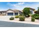 This home features a manicured front yard with lush landscaping and a convenient three-car garage at 2310 W Sienna Bouquet Pl, Phoenix, AZ 85085