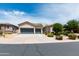 This home features a well-kept front yard, vibrant landscaping, and a spacious three-car garage at 2310 W Sienna Bouquet Pl, Phoenix, AZ 85085