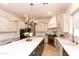 Well-equipped kitchen with oversized island, custom hood, and stainless steel appliances at 2310 W Sienna Bouquet Pl, Phoenix, AZ 85085
