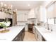 Gourmet kitchen featuring custom cabinets, stainless appliances, and spacious island with seating at 2310 W Sienna Bouquet Pl, Phoenix, AZ 85085
