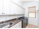 Well-equipped laundry room with sink, washer, and dryer at 2310 W Sienna Bouquet Pl, Phoenix, AZ 85085
