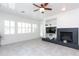 Bright living room featuring a fireplace, tile flooring, and a seamless connection to the outdoors at 2310 W Sienna Bouquet Pl, Phoenix, AZ 85085