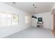 Bright living area with shuttered windows, modern chandelier, and neutral decor at 2310 W Sienna Bouquet Pl, Phoenix, AZ 85085