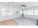 Bright living room with many windows, chandelier, and stylish tile flooring at 2310 W Sienna Bouquet Pl, Phoenix, AZ 85085