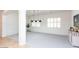Spacious living area with light-filled windows, modern chandelier, and stylish neutral decor at 2310 W Sienna Bouquet Pl, Phoenix, AZ 85085