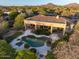 Stunning aerial view of a property featuring a large pool, lush landscaping, and mountain views at 24158 N 78Th Pl, Scottsdale, AZ 85255