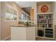 Wet bar featuring granite countertop, built-in bookshelf, and view of exterior at 24158 N 78Th Pl, Scottsdale, AZ 85255