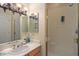 Bathroom with a shower behind glass doors, a single sink, and a decorative chandelier at 24158 N 78Th Pl, Scottsdale, AZ 85255