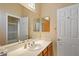 Bathroom with a shower/tub combo, single sink, and a mirrored wall reflecting a doorway to another space at 24158 N 78Th Pl, Scottsdale, AZ 85255
