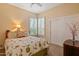 Bright bedroom with floral bedding, plantation shutters on windows, creating a relaxing and inviting personal space at 24158 N 78Th Pl, Scottsdale, AZ 85255