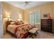 Warm bedroom with upholstered stools at the foot of the bed, plus plantation shutters providing privacy at 24158 N 78Th Pl, Scottsdale, AZ 85255