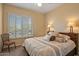 Bright bedroom with plantation shutters, chair in corner, and a serene space at 24158 N 78Th Pl, Scottsdale, AZ 85255