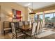 Formal dining room includes seating for ten, beautiful lighting, and large windows to the green backyard at 24158 N 78Th Pl, Scottsdale, AZ 85255