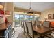 Elegant dining room features large table for ten, bright light fixture, and access to the backyard at 24158 N 78Th Pl, Scottsdale, AZ 85255