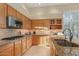 Open kitchen with stone countertops, stainless steel appliances, light wood cabinets, and natural lighting at 24158 N 78Th Pl, Scottsdale, AZ 85255