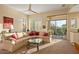 Inviting living room featuring a comfortable sectional sofa and access to a patio at 24158 N 78Th Pl, Scottsdale, AZ 85255