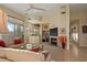 Bright living room with fireplace, built-in shelving, and access to outdoor space at 24158 N 78Th Pl, Scottsdale, AZ 85255