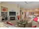 Cozy living room showcasing a fireplace, built-in shelves, and open flow to the kitchen and dining areas at 24158 N 78Th Pl, Scottsdale, AZ 85255