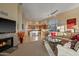 Open-concept living room with fireplace, leading into kitchen and dining area at 24158 N 78Th Pl, Scottsdale, AZ 85255