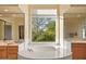 Relaxing main bathroom with soaking tub, dual vanities, and a large window at 24158 N 78Th Pl, Scottsdale, AZ 85255