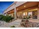 Rear covered patio with multiple seating areas and lush desert landscaping offers views of the backyard at 24158 N 78Th Pl, Scottsdale, AZ 85255