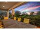 Large outdoor patio table with seating provides backyard dining, with lush landscaping as a backdrop at 24158 N 78Th Pl, Scottsdale, AZ 85255