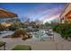 Freeform pool with rock features, desert landscaping, and nearby seating creates a backyard oasis at 24158 N 78Th Pl, Scottsdale, AZ 85255