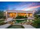 Backyard boasts a freeform pool, lush desert landscape, and covered seating area for relaxing and entertaining at 24158 N 78Th Pl, Scottsdale, AZ 85255