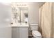 Cozy bathroom featuring a modern vanity, toilet, mirror, and a shower with a stylish curtain at 2503 E Camellia Dr, Gilbert, AZ 85296