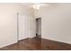 A bedroom with a ceiling fan, closet, and beautiful dark laminate flooring at 2503 E Camellia Dr, Gilbert, AZ 85296