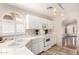 Bright kitchen features white appliances, tile countertops, and a large sink under a window at 2503 E Camellia Dr, Gilbert, AZ 85296