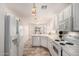 Well-lit kitchen boasts white cabinets, appliances, and a charming breakfast bar area at 2503 E Camellia Dr, Gilbert, AZ 85296