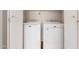 A laundry closet with a white front-load washer and dryer in a clean and well-lit space at 2503 E Camellia Dr, Gilbert, AZ 85296