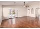 Bright living room with hardwood floors, French doors to the pool, and a ceiling fan at 2503 E Camellia Dr, Gilbert, AZ 85296