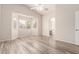 Spacious main bedroom with wood floors, bay window, ceiling fan, and archway to the ensuite bathroom at 2503 E Camellia Dr, Gilbert, AZ 85296