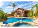 A beautifully designed pool with an attached spa and water feature surrounded by lush landscaping at 2503 E Camellia Dr, Gilbert, AZ 85296