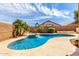 A beautiful freeform pool with a water feature, lush landscaping, and a spacious sun deck at 2503 E Camellia Dr, Gilbert, AZ 85296