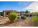 Spacious backyard with desert landscaping, mature shrubs, and a covered patio perfect for relaxing at 2734 W Bowker St, Phoenix, AZ 85041