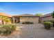 Cozy backyard showcasing desert landscaping, a covered patio, and a neutral color scheme at 2734 W Bowker St, Phoenix, AZ 85041