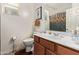 Bright bathroom featuring a wood vanity with a white countertop and a shower with decorative curtain at 2734 W Bowker St, Phoenix, AZ 85041