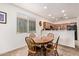 Cozy dining area with a wooden table, chairs, and natural light from a large window at 2734 W Bowker St, Phoenix, AZ 85041
